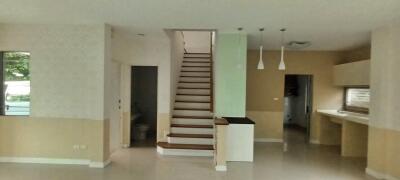 Spacious living area with modern staircase and open plan kitchen
