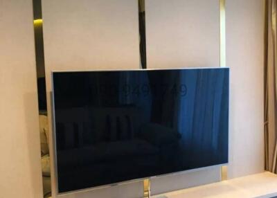 Modern television in a sleek living room with decorative paneling
