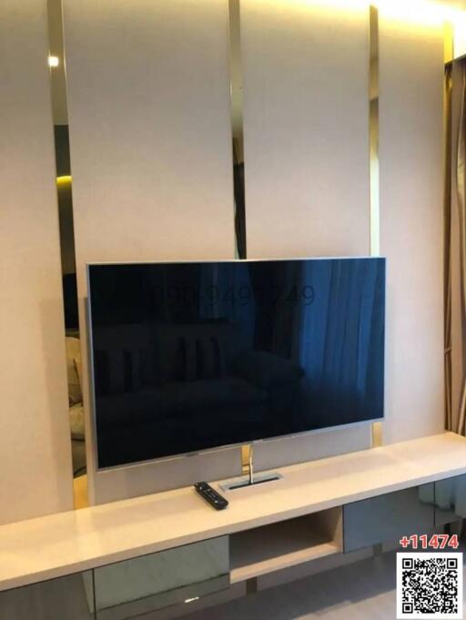 Modern television in a sleek living room with decorative paneling