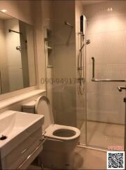 Modern bathroom with glass shower cubicle and toilet
