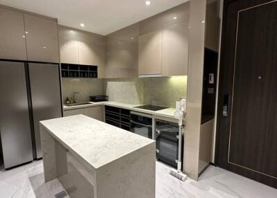 Modern kitchen with marble island and stainless steel appliances