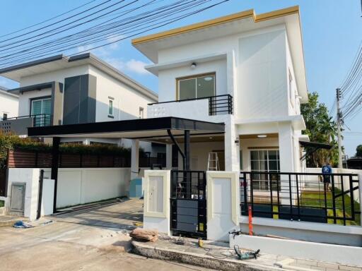 Modern two-story house with a spacious driveway and balcony