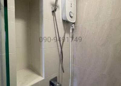 Modern bathroom interior with wall-mounted shower and water heater