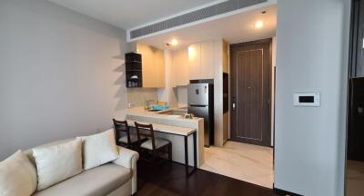 Modern living room connected to a kitchen with sleek design and comfortable seating