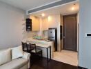 Modern living room connected to a kitchen with sleek design and comfortable seating