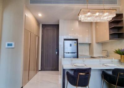 Modern kitchen with integrated appliances and elegant chandelier