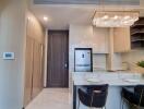 Modern kitchen with integrated appliances and elegant chandelier