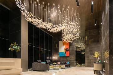 Elegant lobby area with modern artistic chandelier and plush seating
