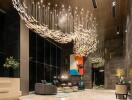 Elegant lobby area with modern artistic chandelier and plush seating