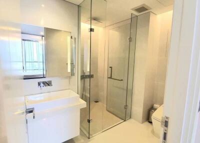 Modern bathroom interior with glass shower enclosure and white fixtures