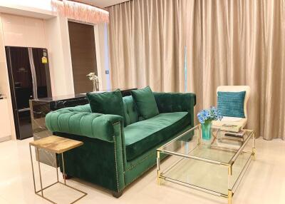 Elegant living room with green velvet sofa and minimalist decor