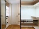 Modern bedroom with built-in wardrobes and wooden floors