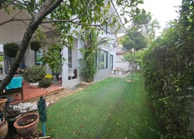 Exterior view of a suburban house with lush garden