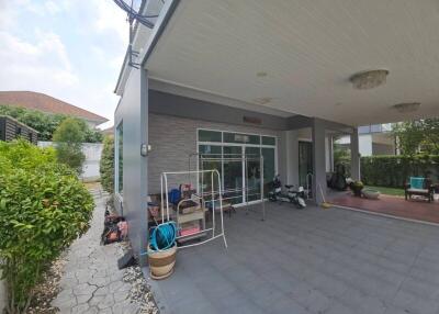 Spacious covered patio area with outdoor seating and lawn view