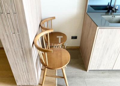 Modern kitchen corner with stylish wooden chair and simplistic cabinet design