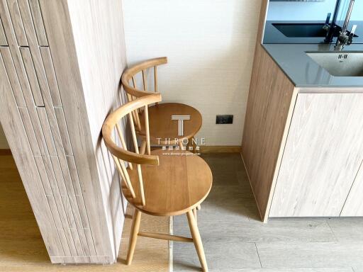 Modern kitchen corner with stylish wooden chair and simplistic cabinet design