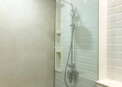 Modern bathroom with glass shower and elegant tiling