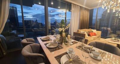 Elegant living room with dining area and city view