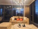 Elegant living room with sofa and chandelier at twilight