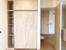 Contemporary bedroom with built-in wooden wardrobe and shelving