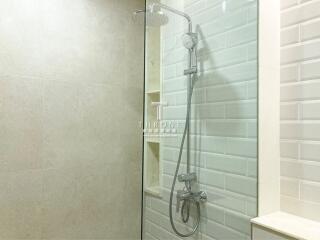 Modern bathroom with glass shower and tiled walls