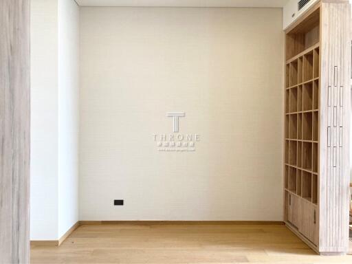 Spacious empty bedroom with wooden flooring and built-in shelving
