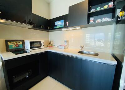 Modern kitchen with dark cabinetry and integrated appliances