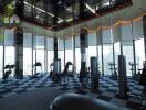 Spacious gym with modern equipment and panoramic city views