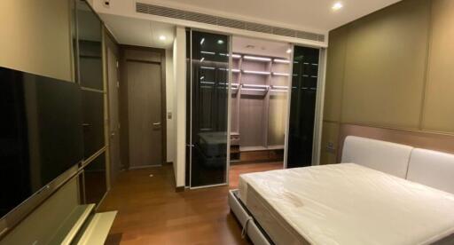 Modern bedroom with built-in wardrobes and ambient lighting