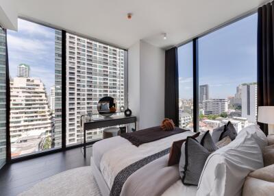 Modern bedroom with large windows overlooking the city