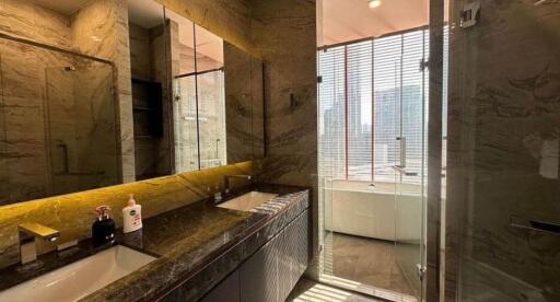 modern bathroom with marble finishes and glass shower