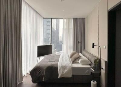 Modern bedroom with expansive windows and city view