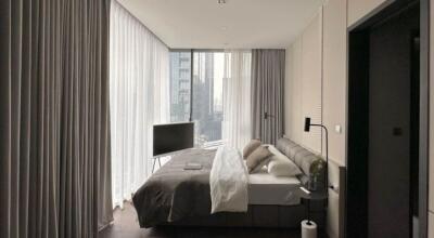 Modern bedroom with expansive windows and city view