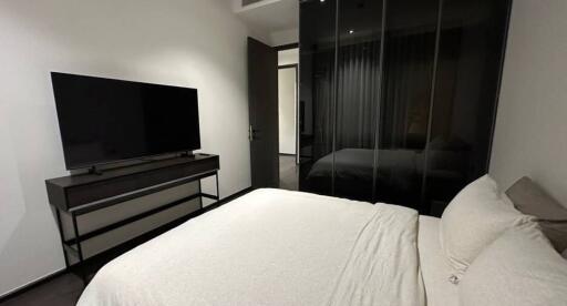 Modern bedroom with television and sliding door wardrobe