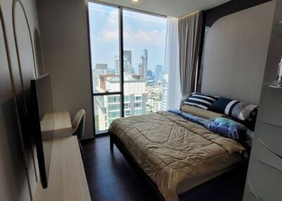 Modern bedroom with a city view and balcony access