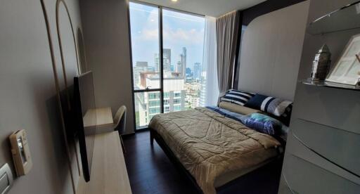 Modern bedroom with a city view and balcony access