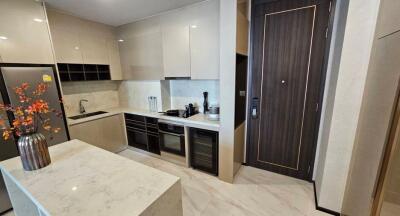 Modern kitchen with marble countertops and built-in appliances