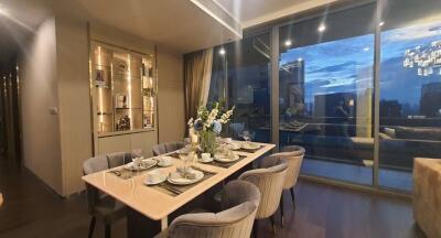 Elegantly set dining table in a modern apartment with city views at night