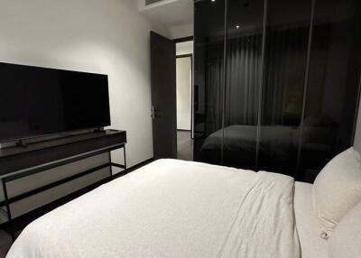 Modern bedroom with television and mirrored wardrobe