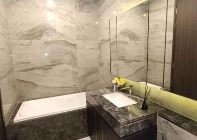 Spacious modern bathroom with marble tiles and elegant fixtures