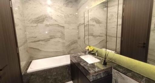 Spacious modern bathroom with marble tiles and elegant fixtures