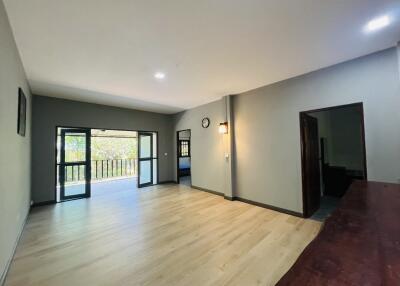 Spacious living room with hardwood floors and balcony access