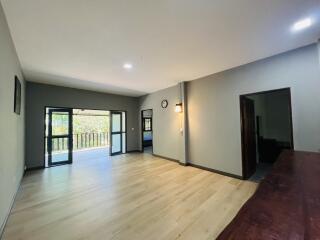 Spacious living room with hardwood floors and balcony access