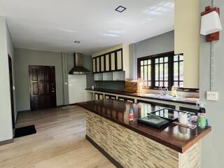 Spacious kitchen with modern appliances and wooden finishes