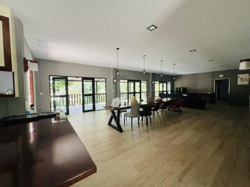 Spacious open plan living area with kitchen, dining, and lounge spaces