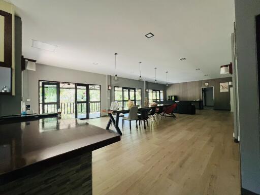 Spacious open-plan living area with kitchen, dining, and lounge zones