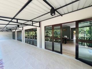Spacious covered patio with large sliding doors leading to the interior
