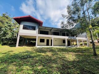 Modern two-story house surrounded by nature