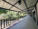 Spacious covered porch with tiled flooring and garden view