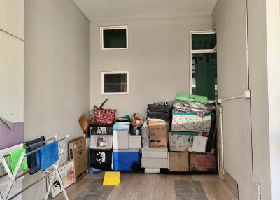 Cluttered garage space with storage boxes and household items